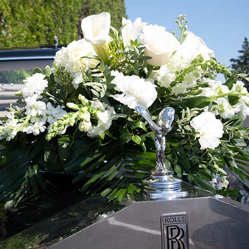 Front of Rolls Royce with wreath of white lilies and Lilies of the Valley